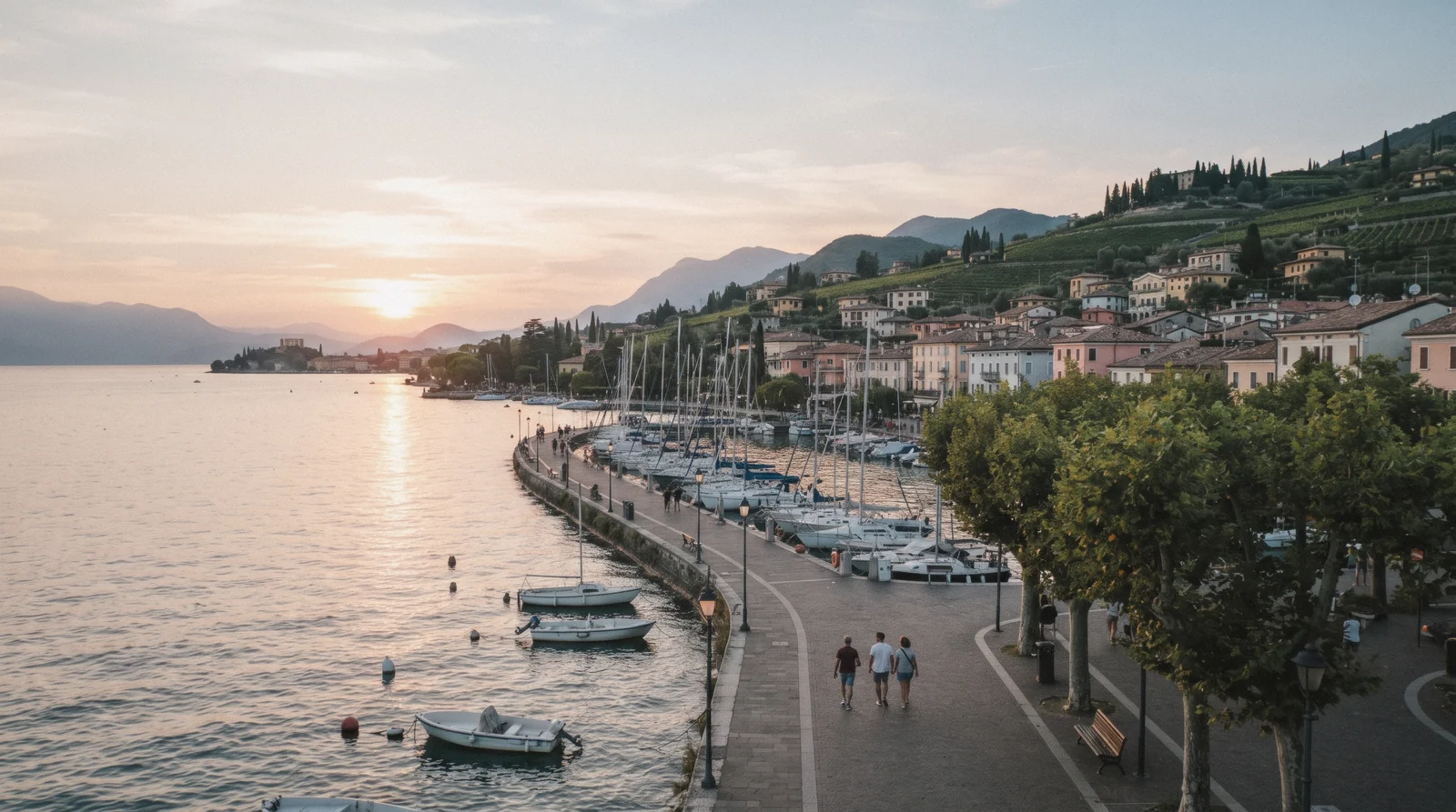 The lakefront promenade of Bardolino with vineyard hills behind, on the east shore of Lake Garda, Italy