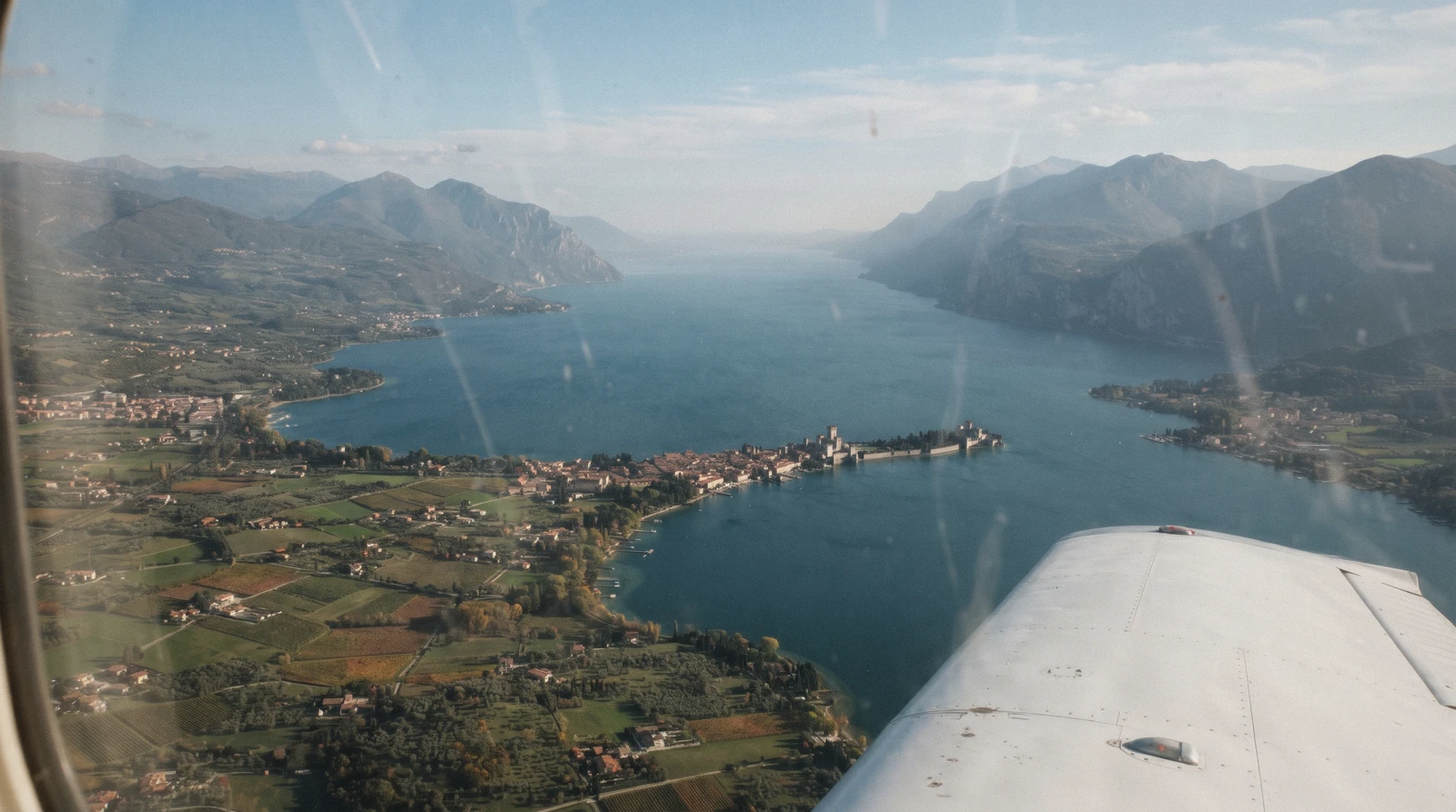 The Sirmione peninsula and southern Lake Garda, Italy, seen from a plane approaching the closest airport
