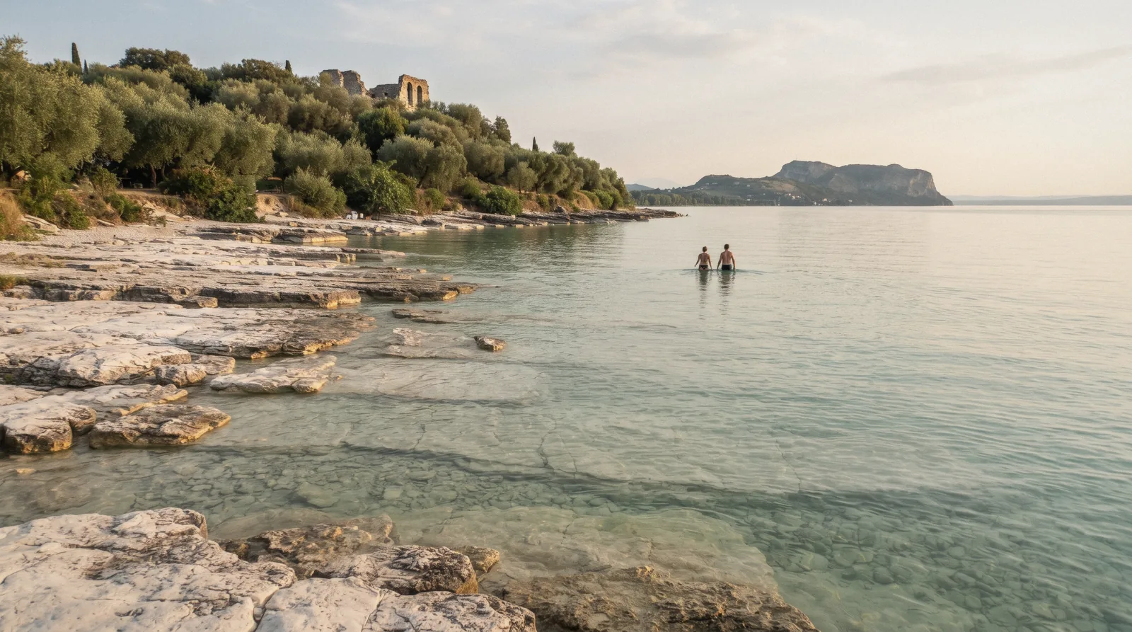 White limestone shelves and shallow water at Jamaica Beach, Sirmione, one of the Lake Garda beaches, Italy