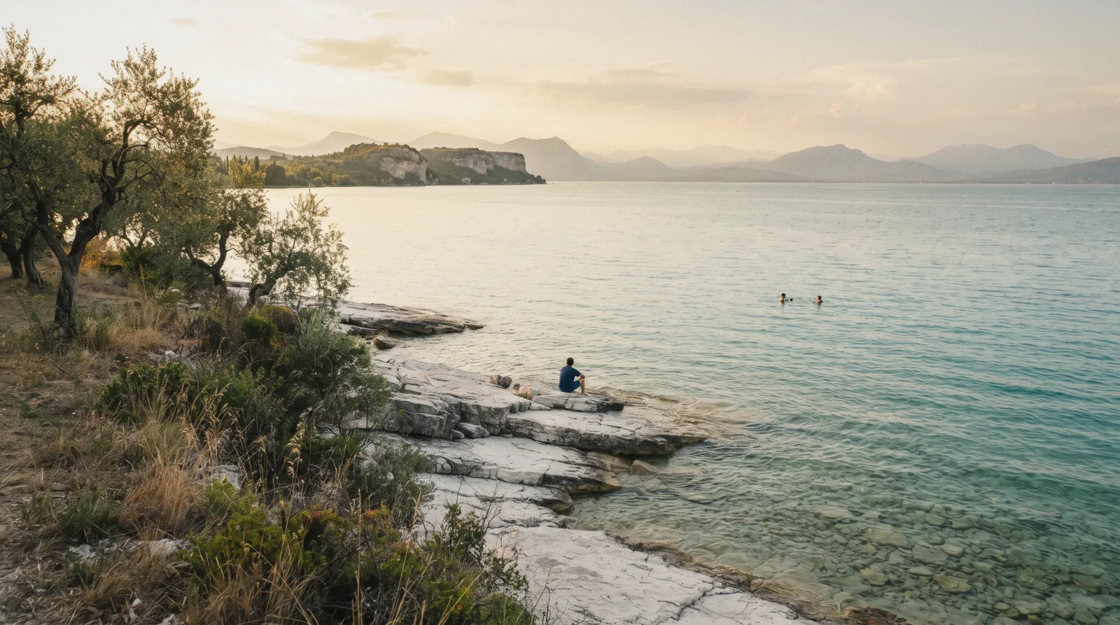 Golden hour over the wide southern basin of Lake Garda from the rocks at Sirmione, Italy, the lake weighed against Lake Como
