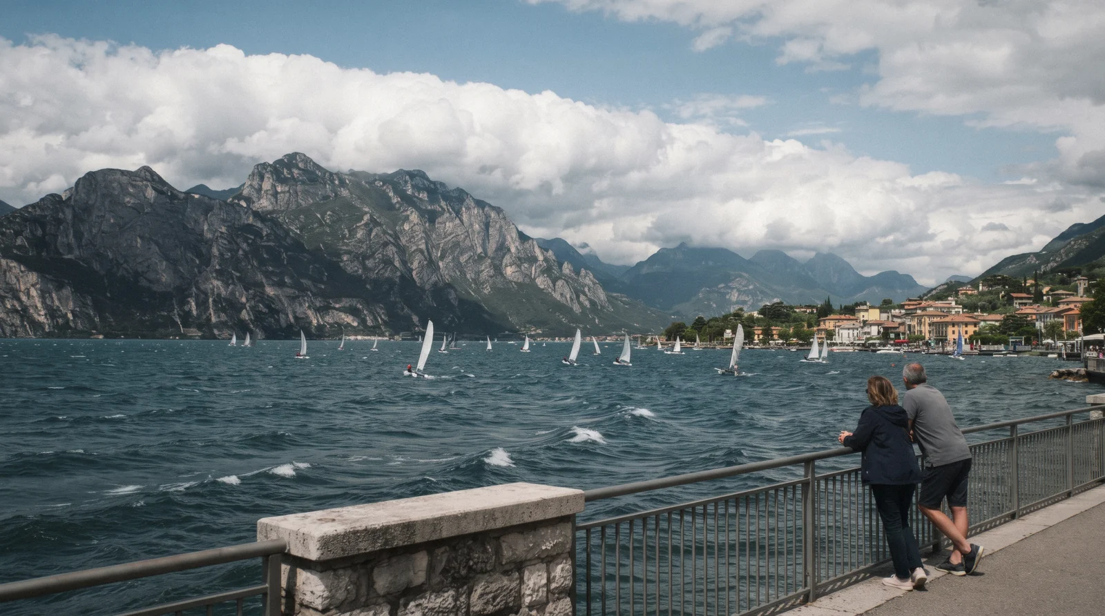 Wind-ruffled water at the north tip of Lake Garda, Italy, with Monte Baldo and building clouds over the mountains