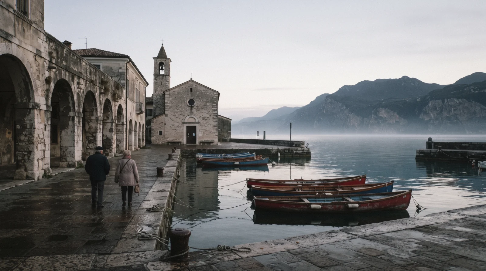 The old harbour of Lazise with the Venetian customs house on the east shore of Lake Garda, Italy