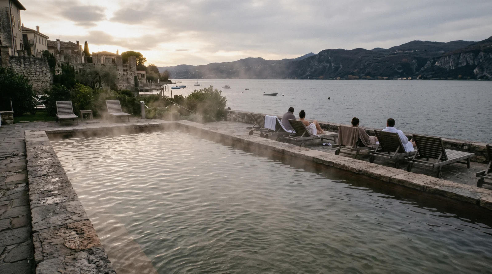 Steam over the outdoor thermal pool of the Terme di Sirmione beside the lake, Lake Garda, Italy