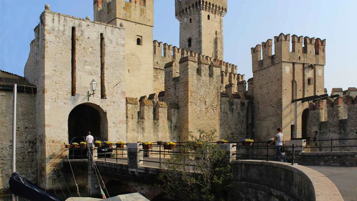 The Scaligero Castle moat and towers at the entrance to Sirmione, Lake Garda