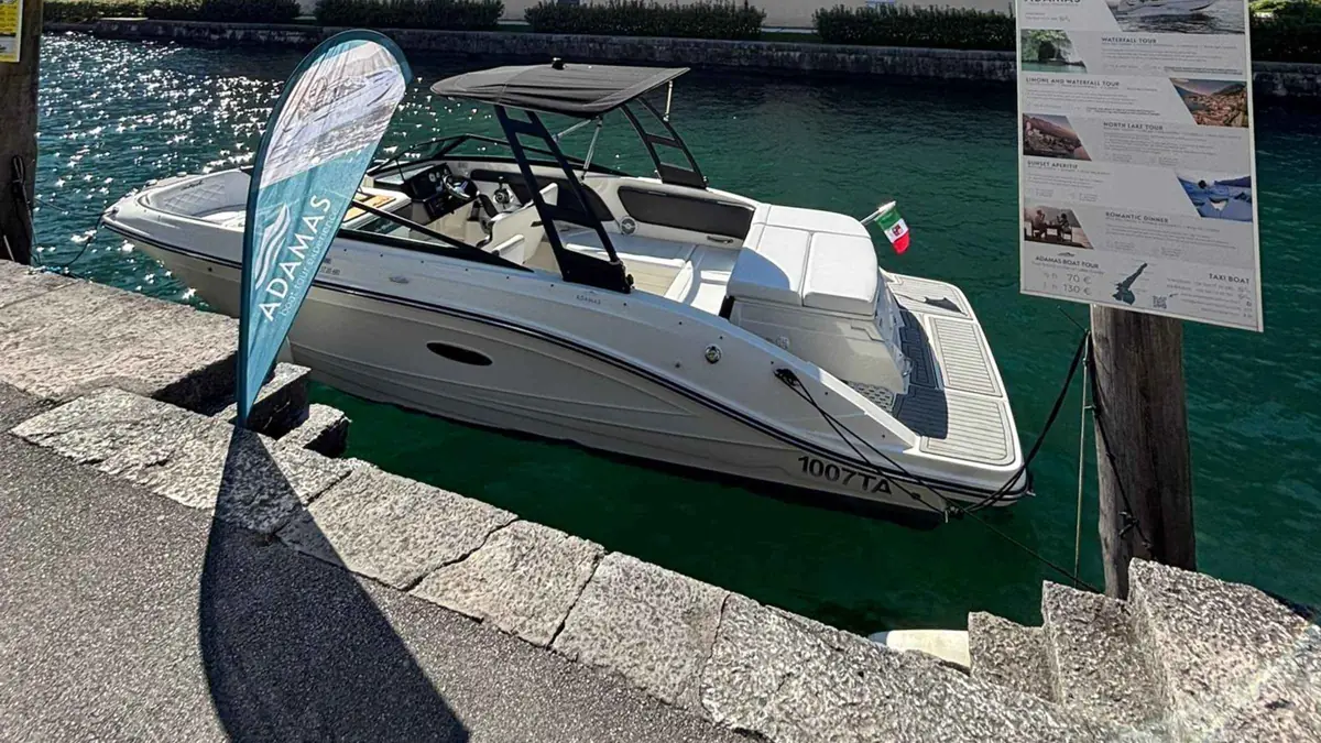 A speedboat on Lake Garda off Riva del Garda with the Trentino mountains behind