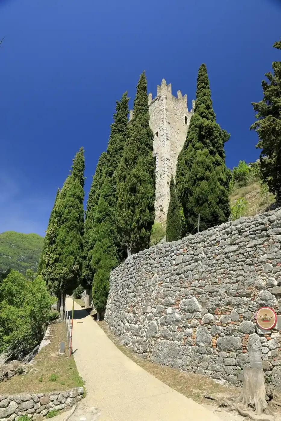 The main tower of Castello di Arco above the castle path, near Lake Garda, Italy