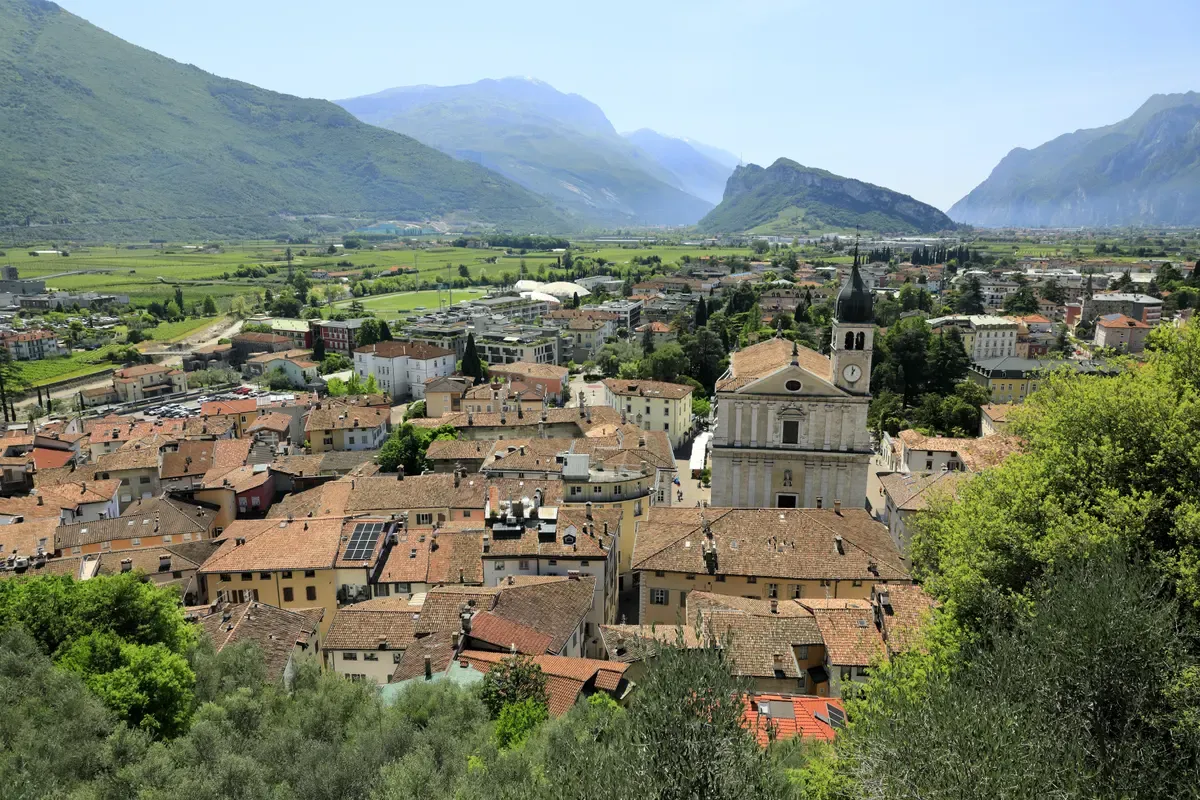 Arco and its Collegiata church seen from the castle hill in the Sarca valley near Lake Garda, Italy