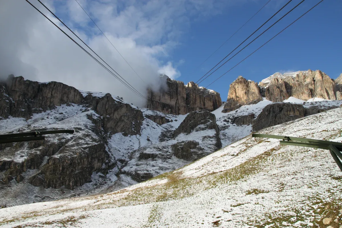 Sass Pordoi and the cable car line seen from the Pordoi Pass in the Dolomites, a day trip from Lake Garda, Italy
