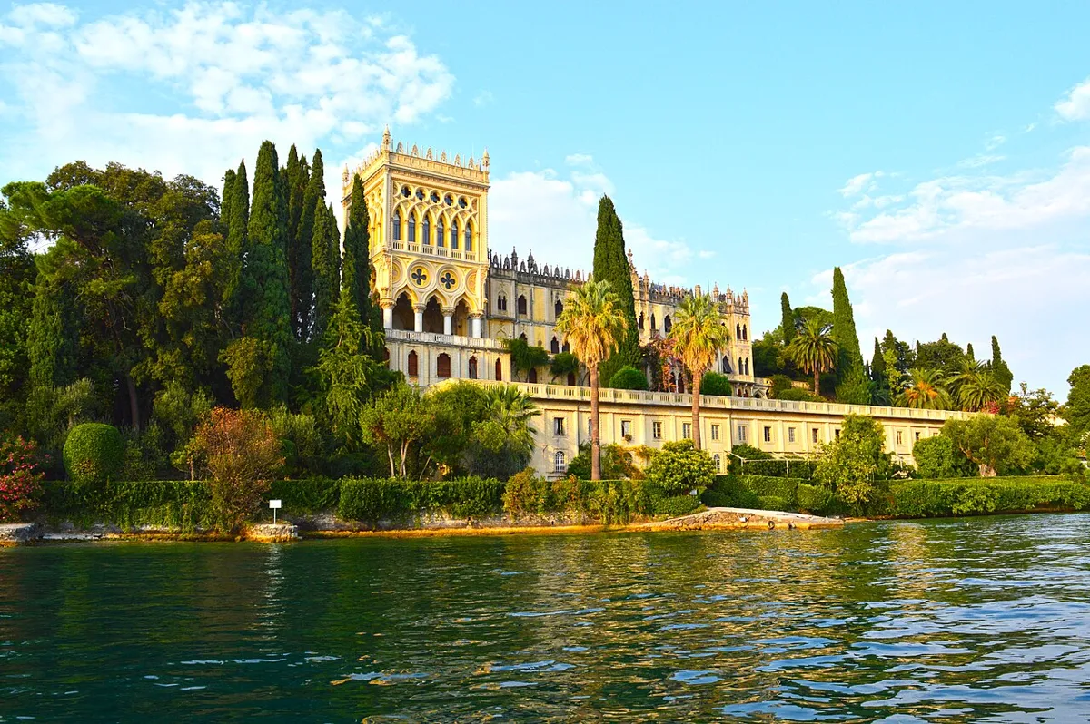 The neo-Gothic Villa Borghese Cavazza above its gardens on Isola del Garda, Lake Garda, Italy