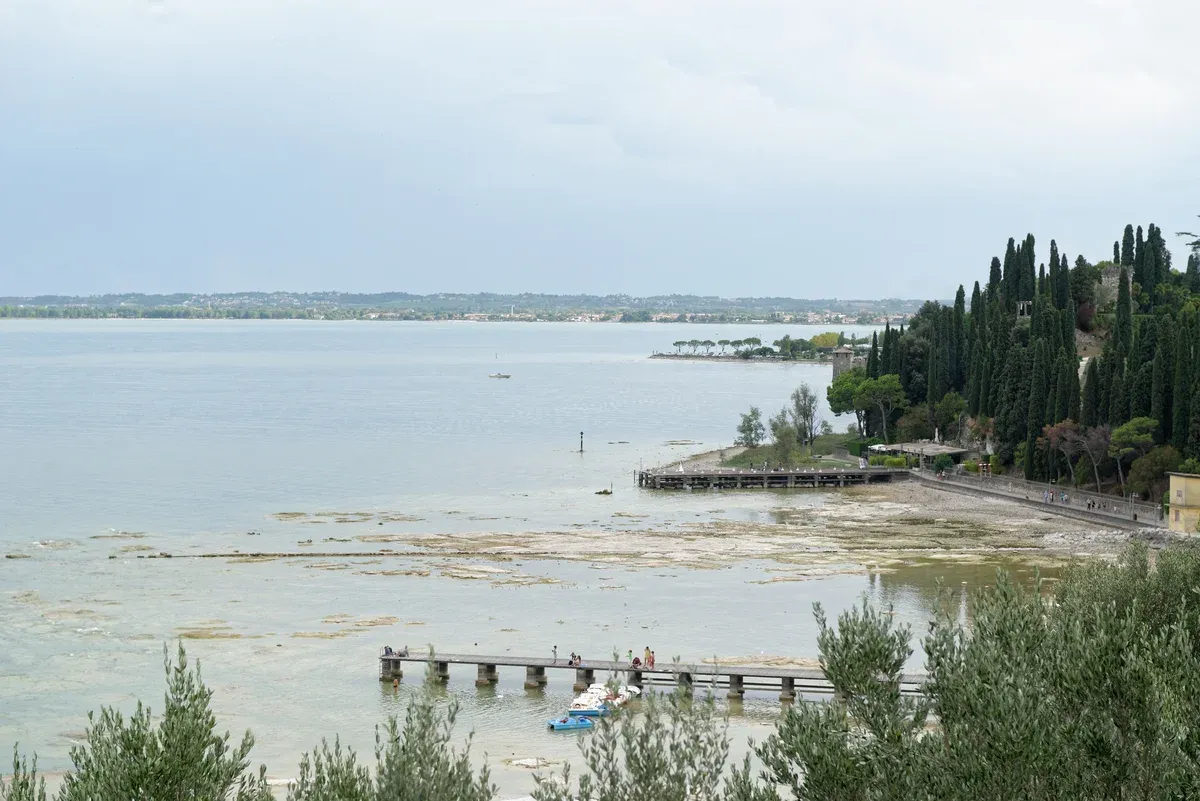The jetty and shallow shelf of Lido delle Bionde seen from the Grottoes of Catullus, Sirmione, Lake Garda, Italy