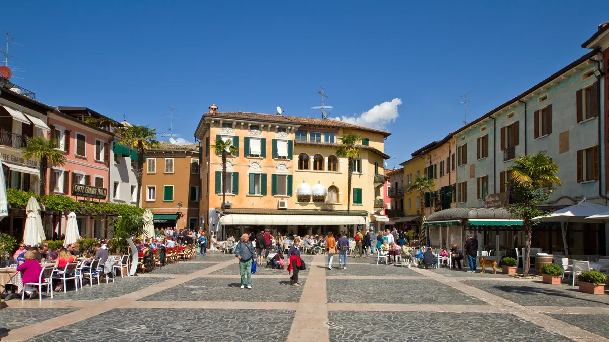 Piazza Carducci with cafe tables in Sirmione old town on a Lake Garda in one day trip, Italy