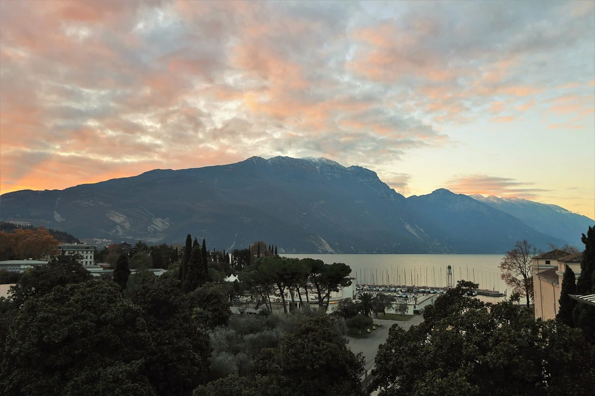 Riva del Garda harbour under Monte Baldo at dusk, the north tip of Lake Garda, Italy