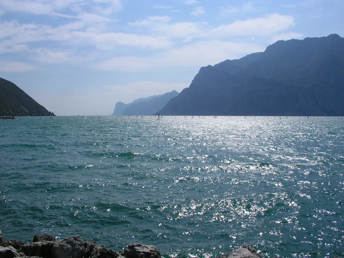 The north basin of Lake Garda seen from Torbole, Italy, with cliffs on both sides of the water