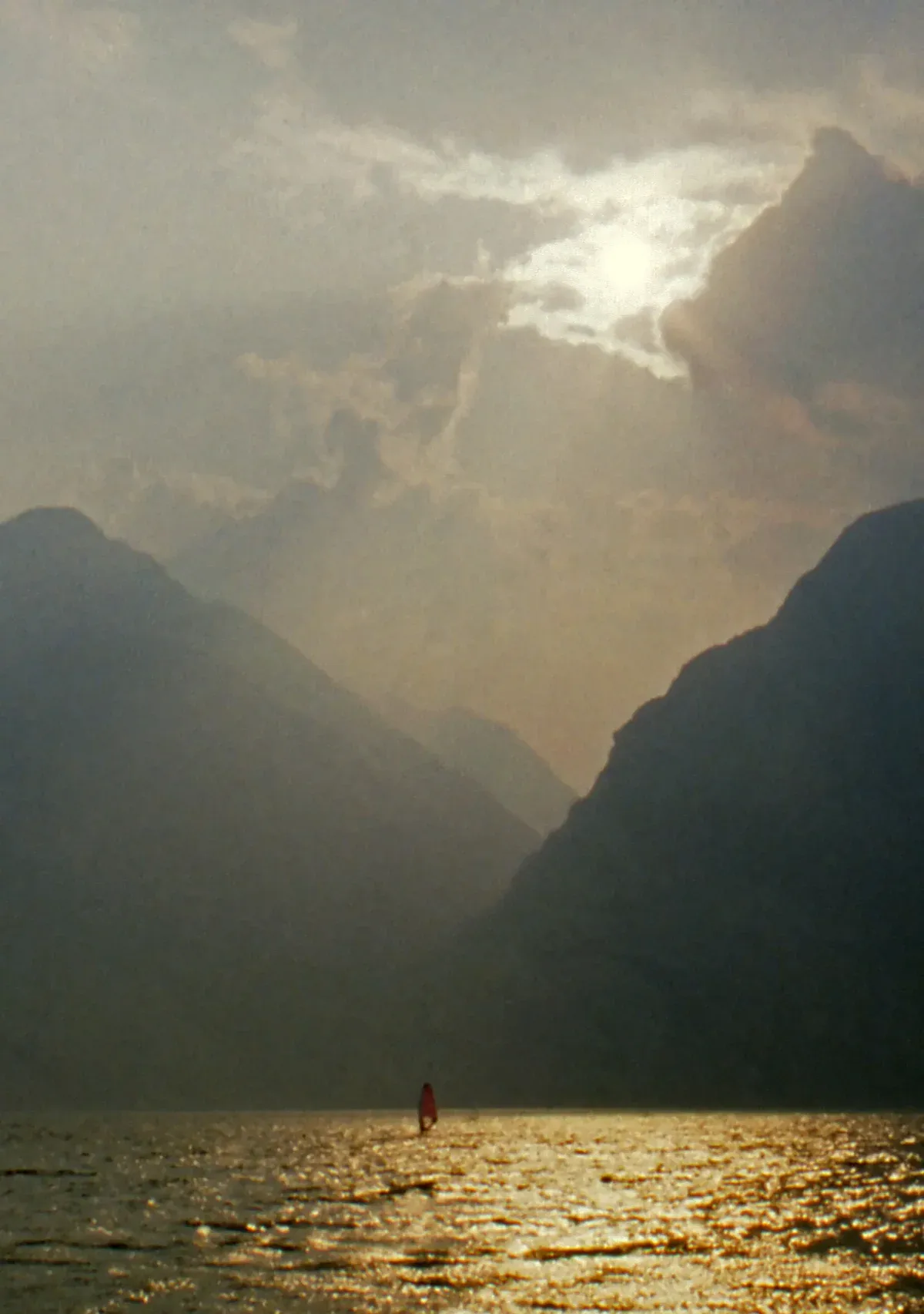 A lone windsurfer on Lake Garda off Malcesine, Italy, in the evening light