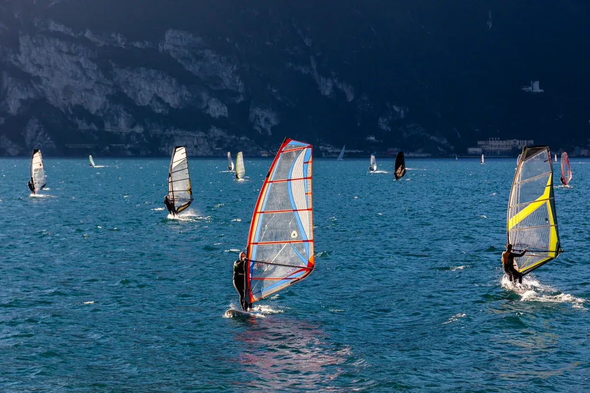 Windsurfers under the cliffs at the north end of Lake Garda, Italy