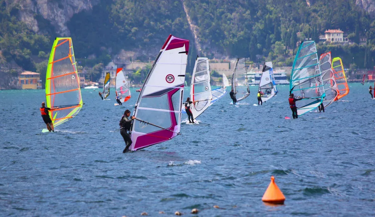 Windsurfers sailing off Torbole on the northern tip of Lake Garda, Italy