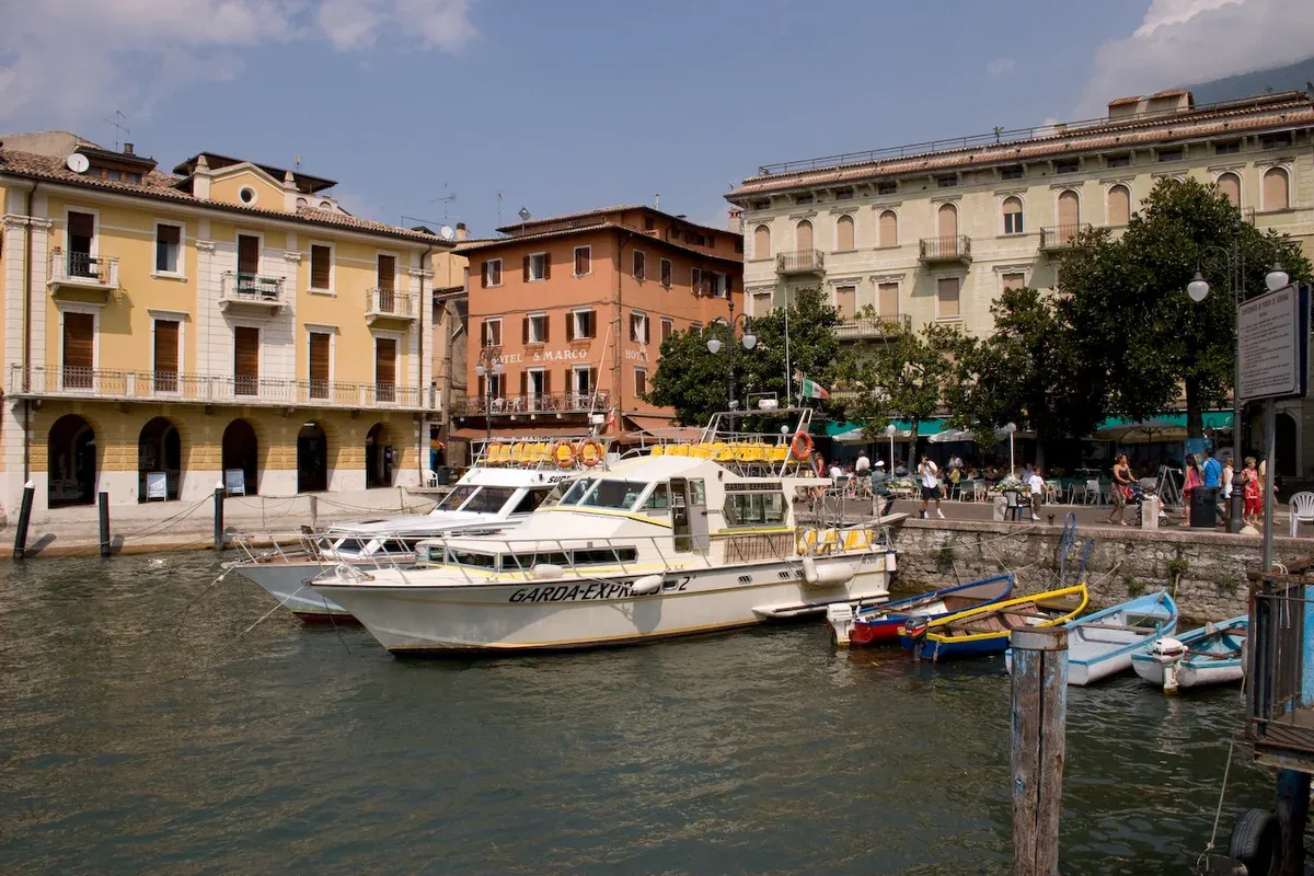 The northern side of Malcesine harbour on Lake Garda, Italy, with boats moored below the old town