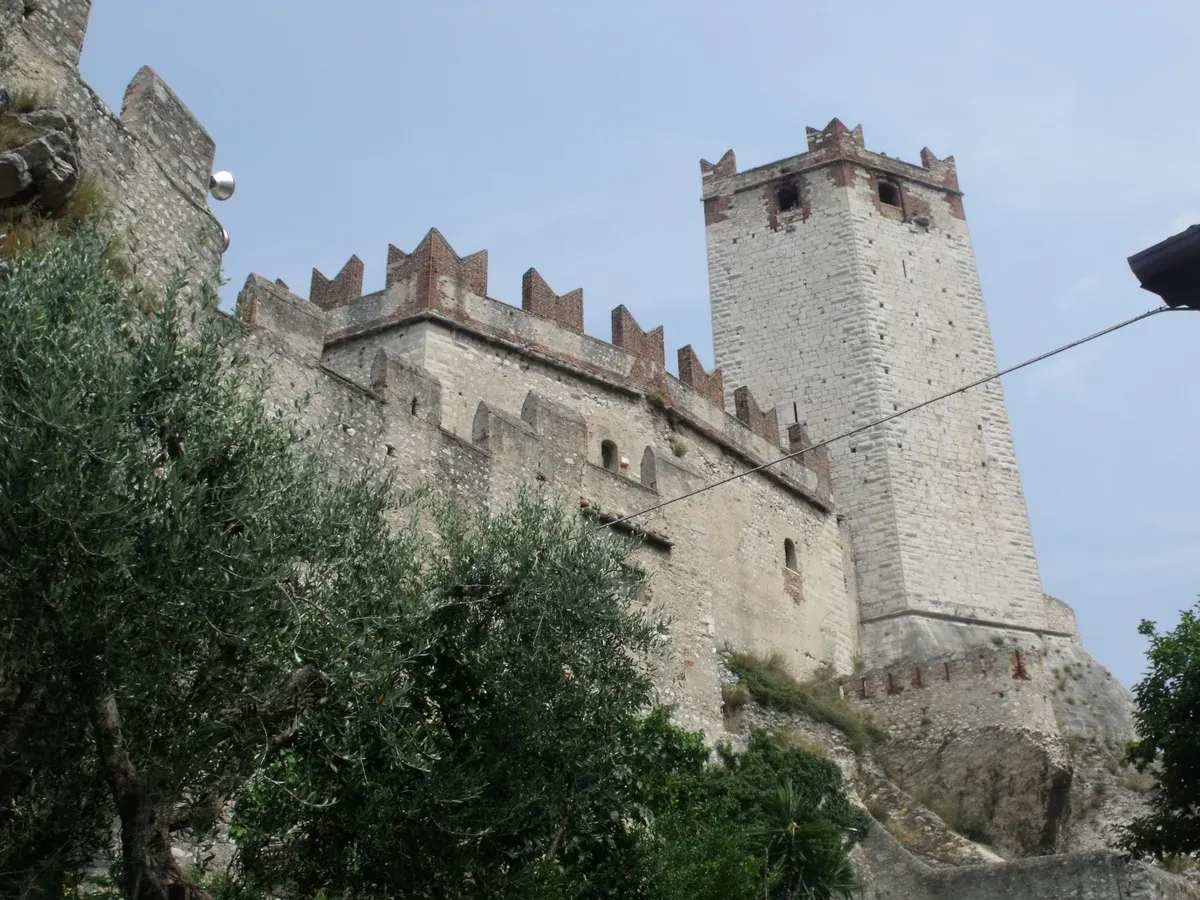 The tower and battlemented walls of the Castello Scaligero di Malcesine seen from below, Lake Garda, Italy
