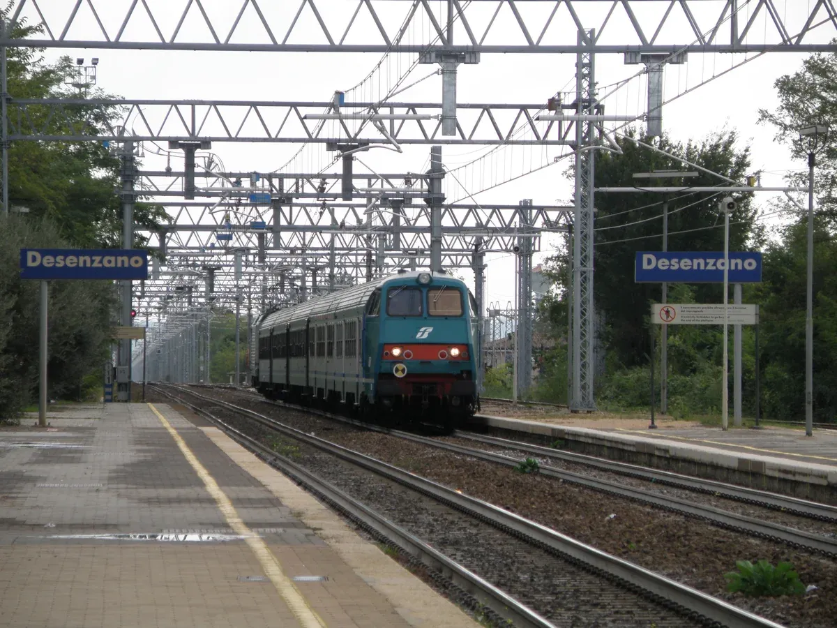 A regional train bound for Milano Centrale arriving at Desenzano del Garda-Sirmione station, Lake Garda, Italy