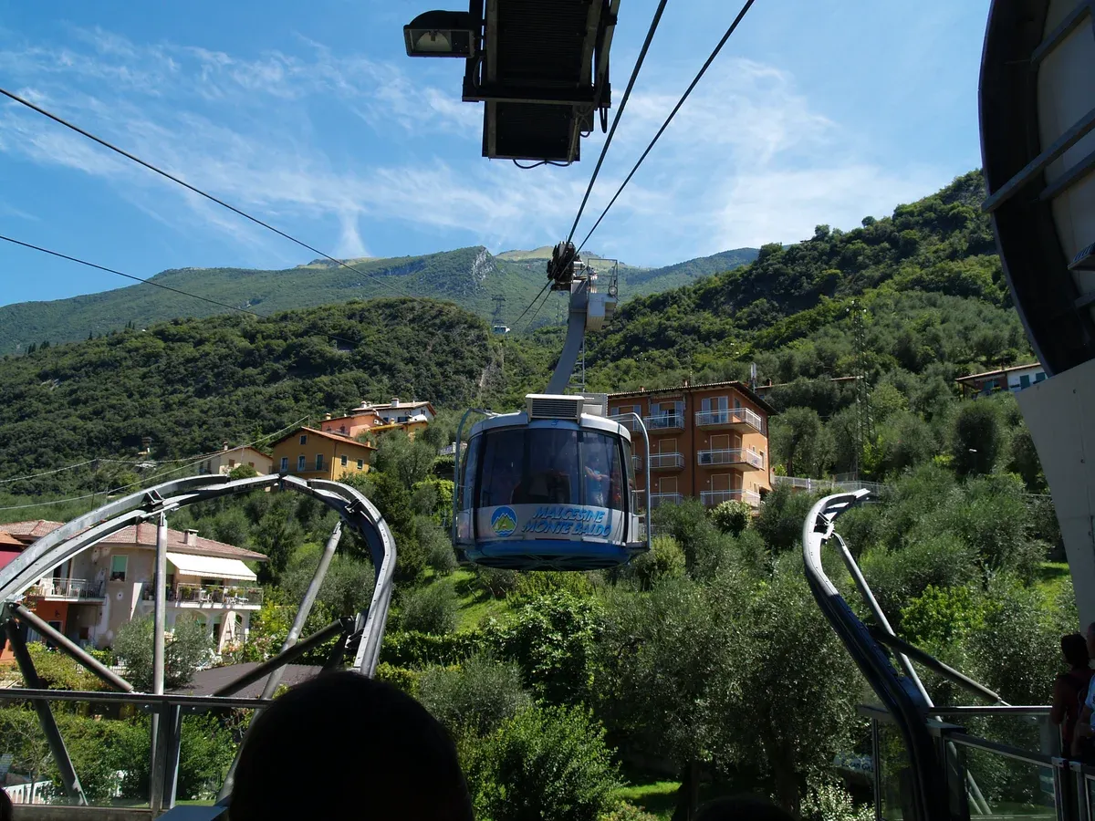 A rotating cabin of the Monte Baldo cable car leaving a station above Malcesine, Lake Garda, Italy