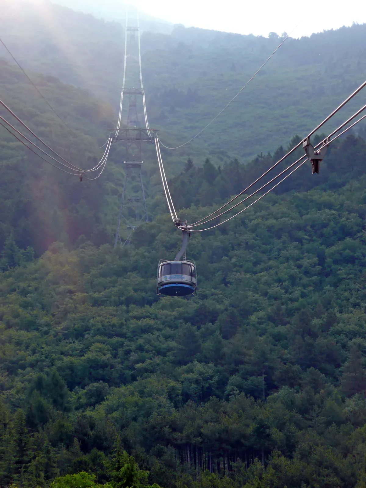 A Monte Baldo cable car cabin on its cables near the San Michele intermediate station above Lake Garda, Italy