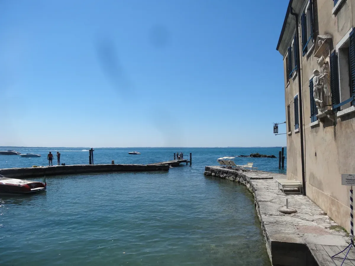 The small walled harbour beside the Locanda San Vigilio on Punta San Vigilio, Lake Garda, Italy
