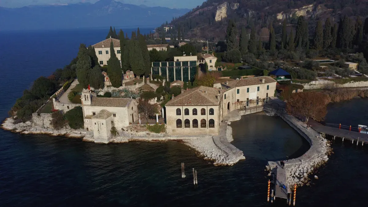 Aerial view of Villa Guarienti, the church and the harbour on Punta San Vigilio, Lake Garda, Italy