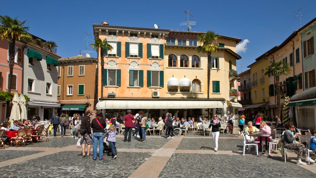 Piazza Carducci in Sirmione old town with cafe tables, Lake Garda, Italy