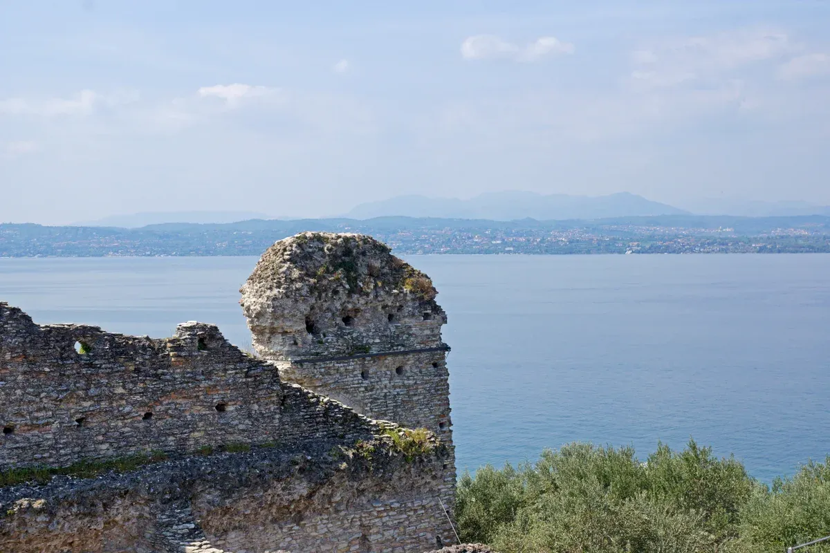 Roman walls of the Grottoes of Catullus above the water at the tip of the Sirmione peninsula, Lake Garda, Italy