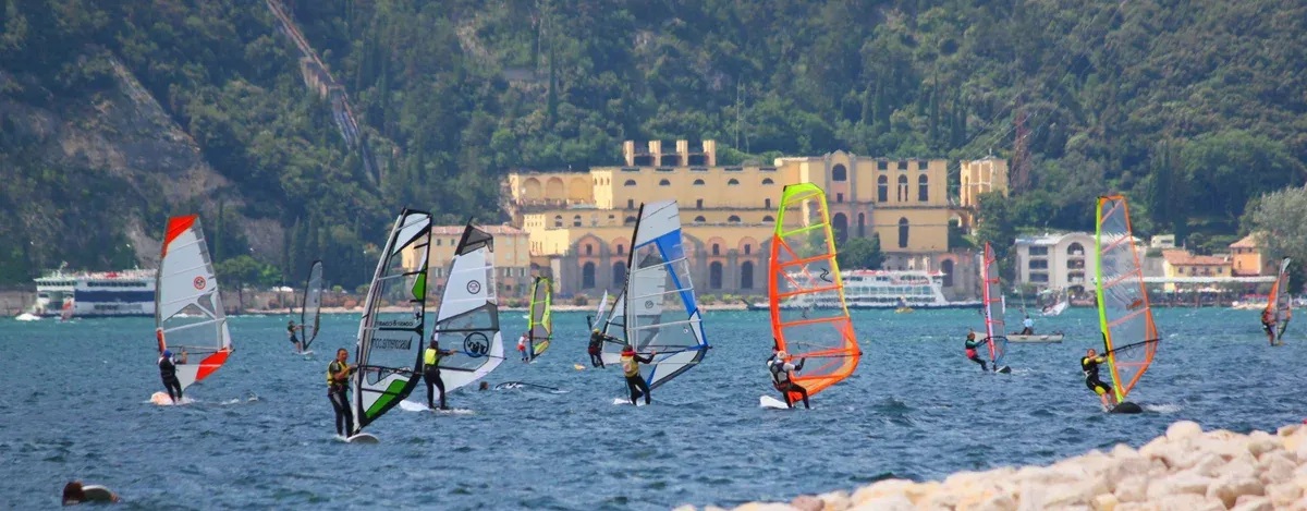 Windsurfers off Torbole heading toward Riva del Garda on Lake Garda, Italy