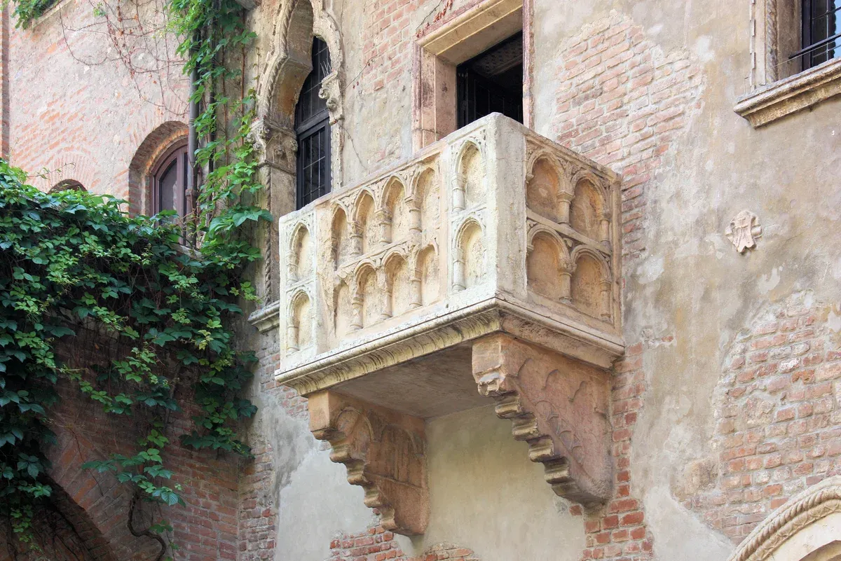 The stone balcony in the courtyard of Juliet's House in Verona, a day trip from Lake Garda, Italy